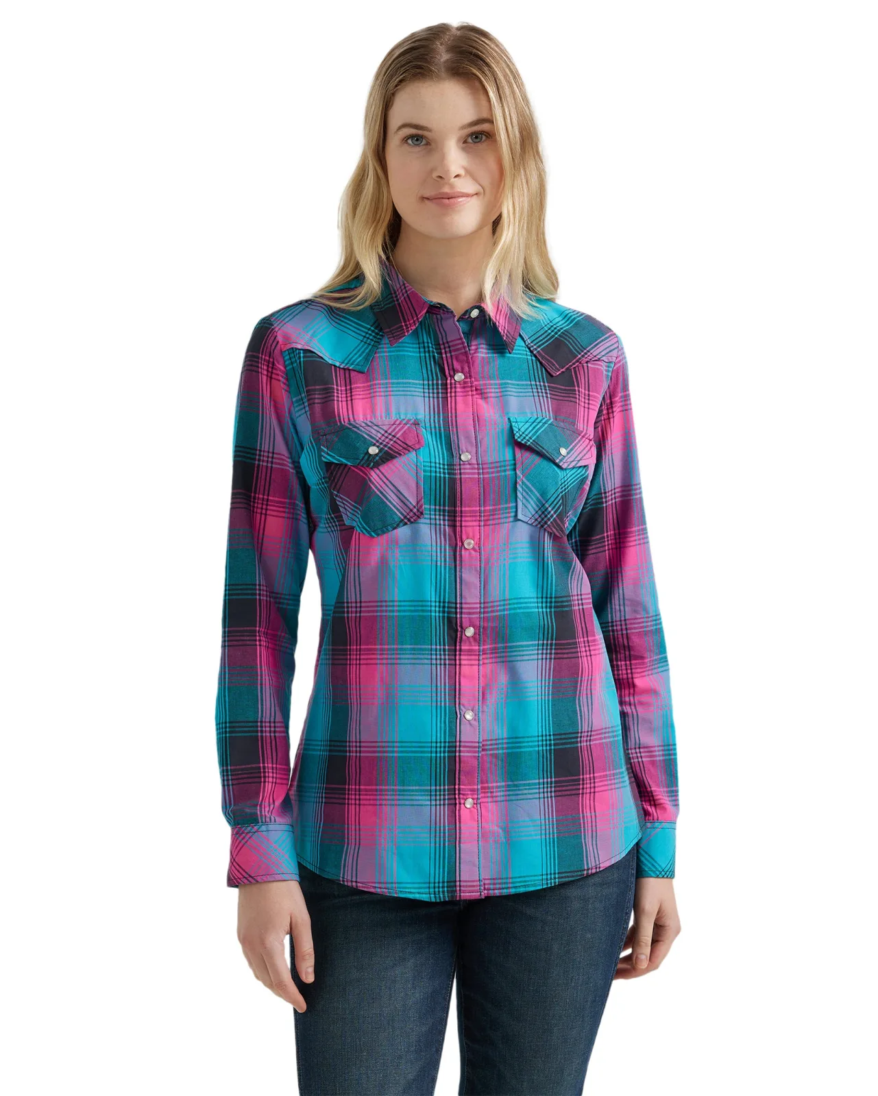 Woman in a pink, turquoise and black plaid western shirt, front view, with pearl snaps, snap flap pockets and pointed yokes
