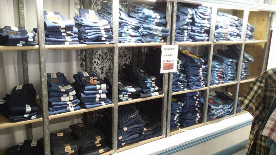 Shelves of jeans and apparel inside Baker Feed & Country Store.
