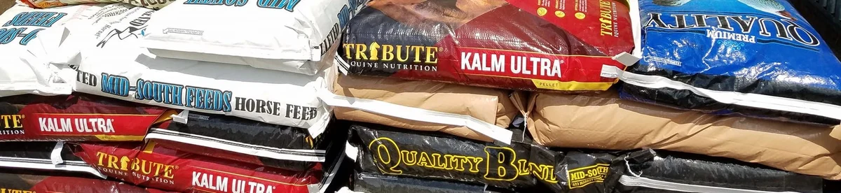 Stacks of Tribute and Mid-South feed bags at Baker Feed.